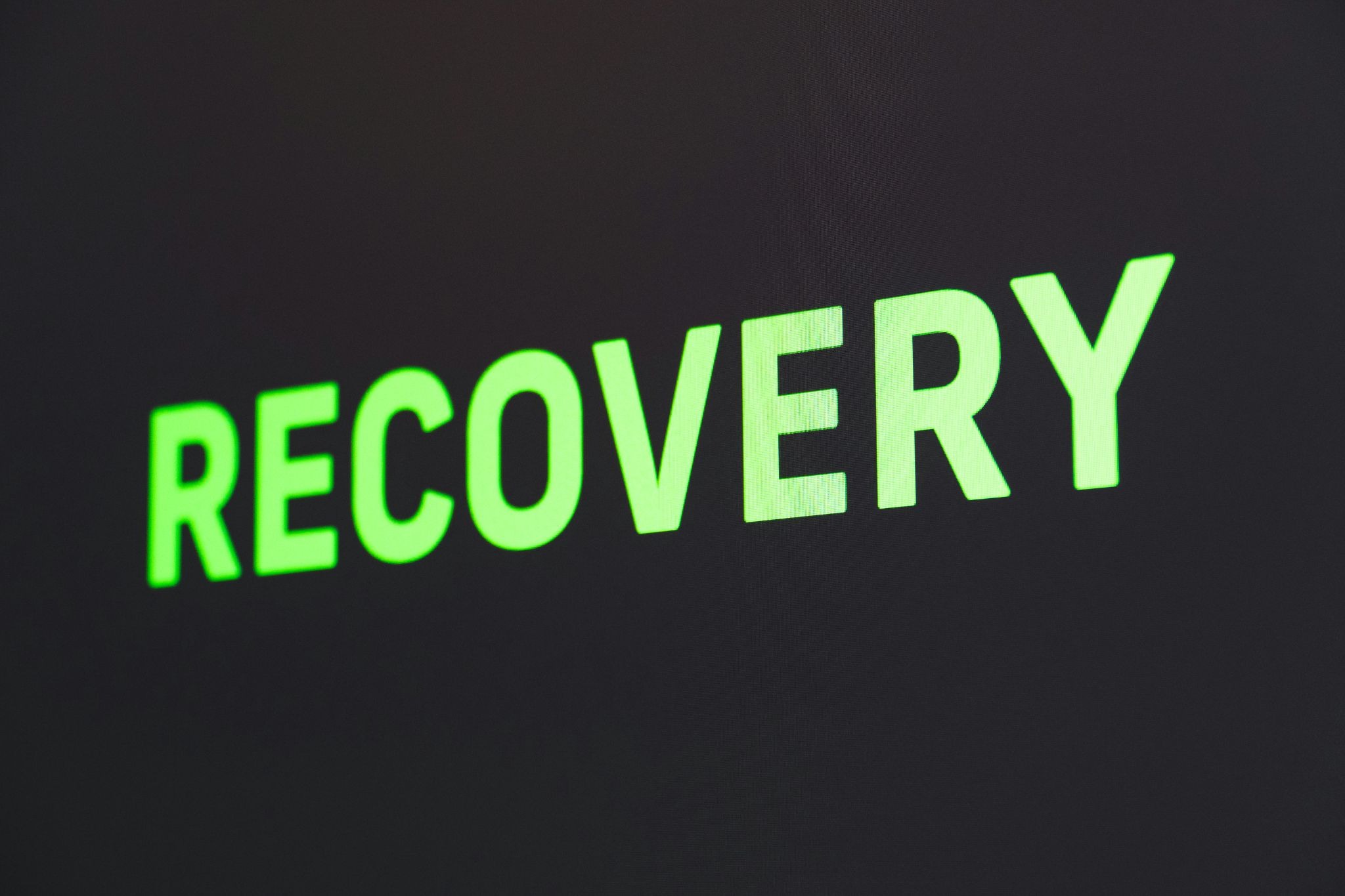 The word "RECOVERY" in bright green block letters on a dark background, illustrating the importance of a tested HubSpot restore process.